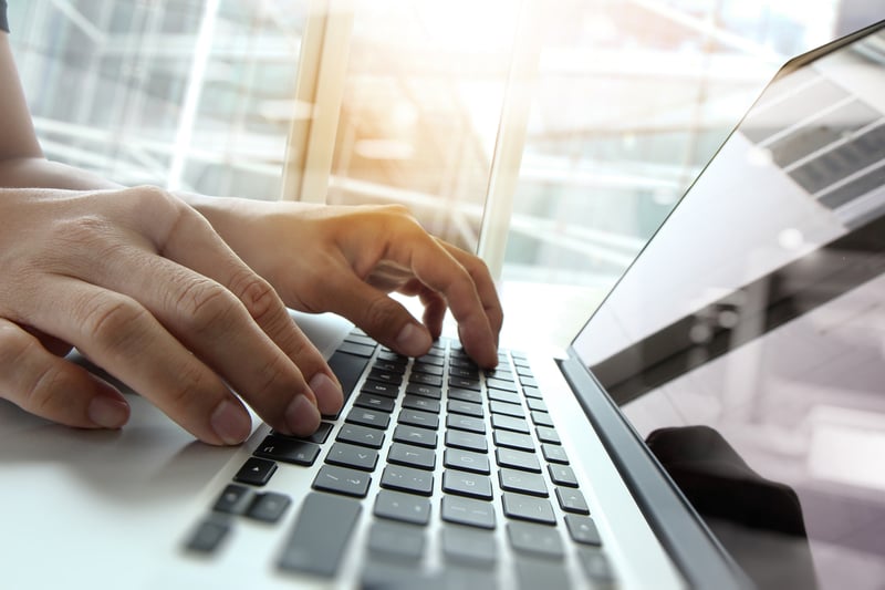 Double exposure of business man hand working on blank screen laptop computer on wooden desk as concept